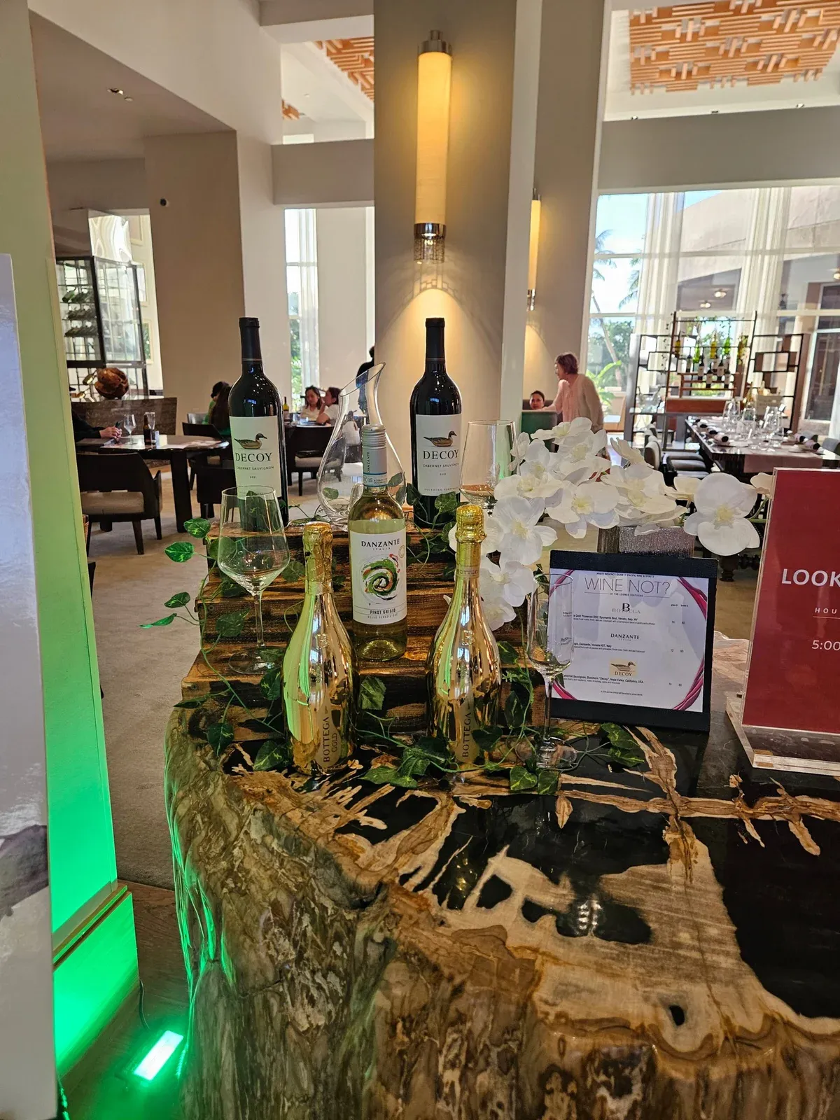 Bottega gold sparkling bottles and wines on a wooden display in the hotel lounge