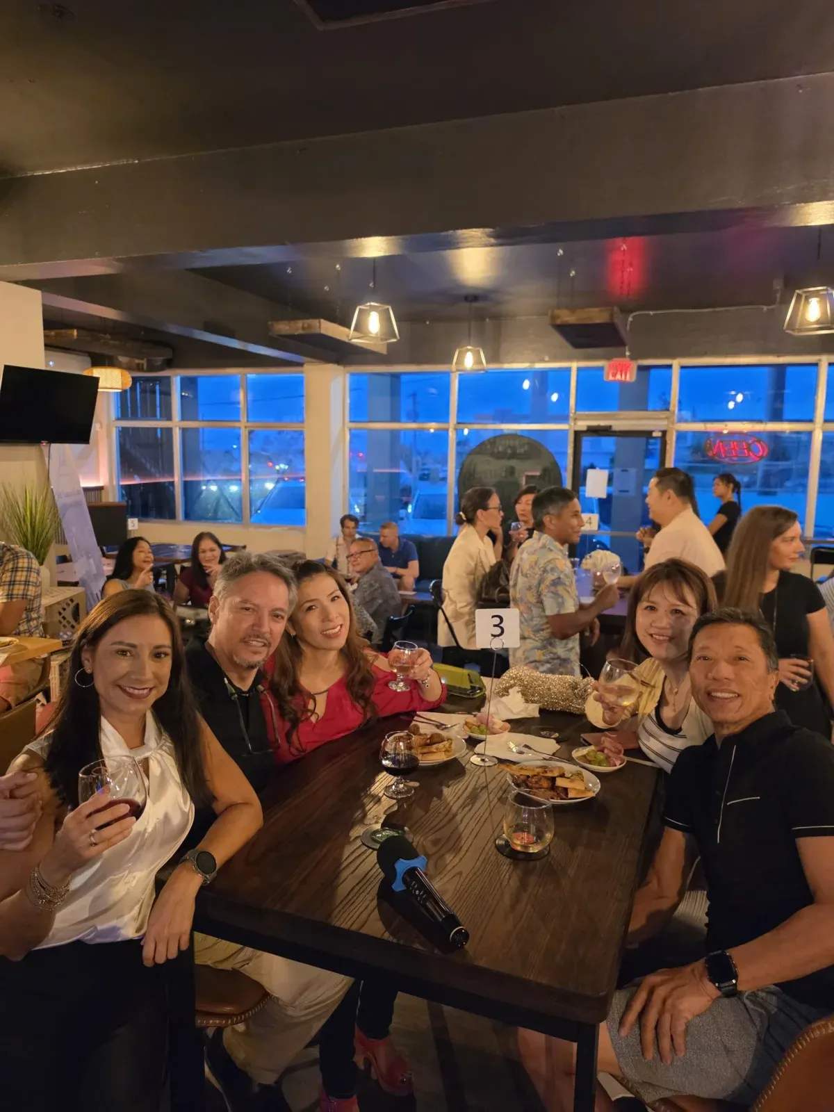 Guests around the table at Beans and Barrels in Maite